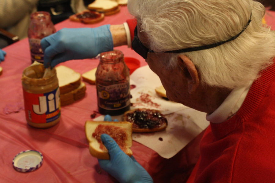 The senior citizens at the San Carlos Elms make peanut butter and jelly sandwiches for the homeless.
