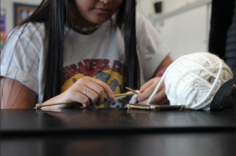 Mairwyn Forster, a sophomore, works on knitting a new product.