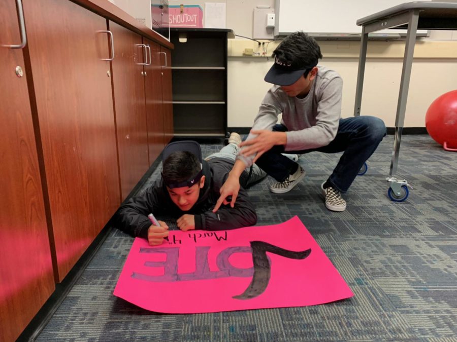 Freshmen Jono Sison and Nate Hsich create a poster publicizing the election. 