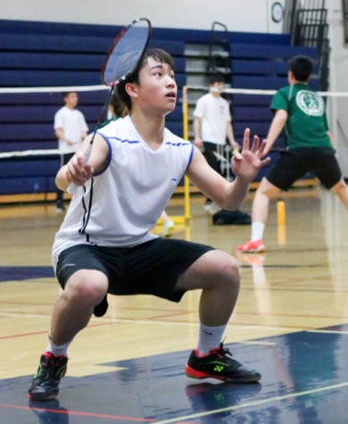 After losing his second game, sophomore Ethan Liu regains his focus for the third game and prepares to clear a smash from his opponents.