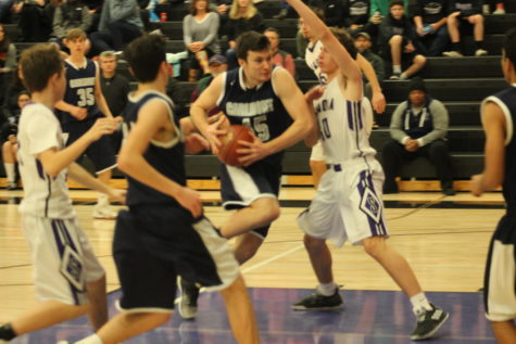 Sophomore center Will Hesselgren attempts a layup through Sequoia defenders.