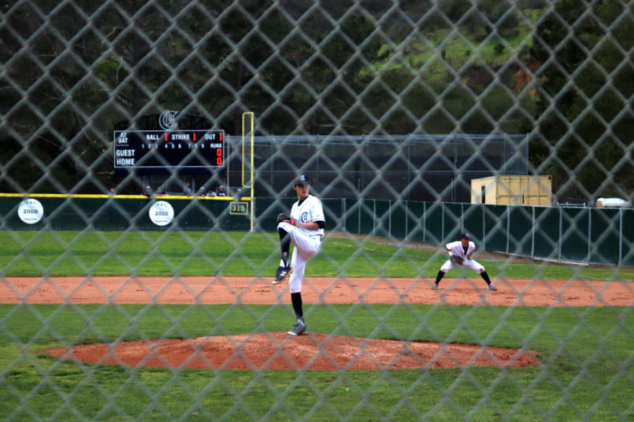 Starting pitcher Tai Takahashi, a sophomore, winds up to throw a pitch to the batter.