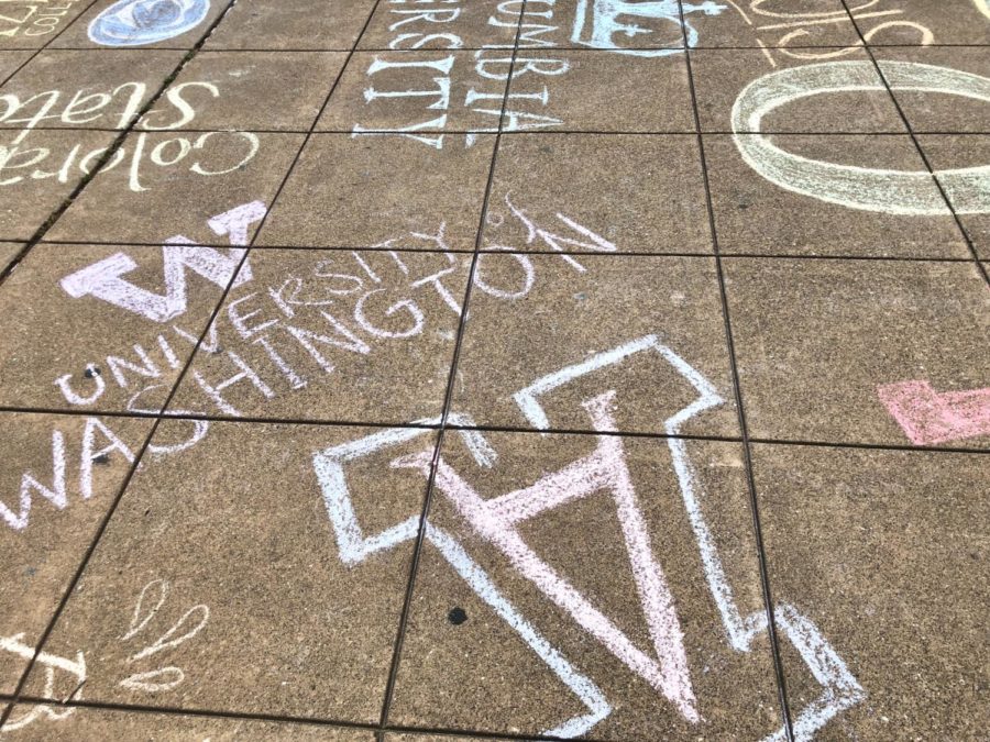 Seniors+decorate+the+quad+with+chalk+logos+of+their+colleges.+
