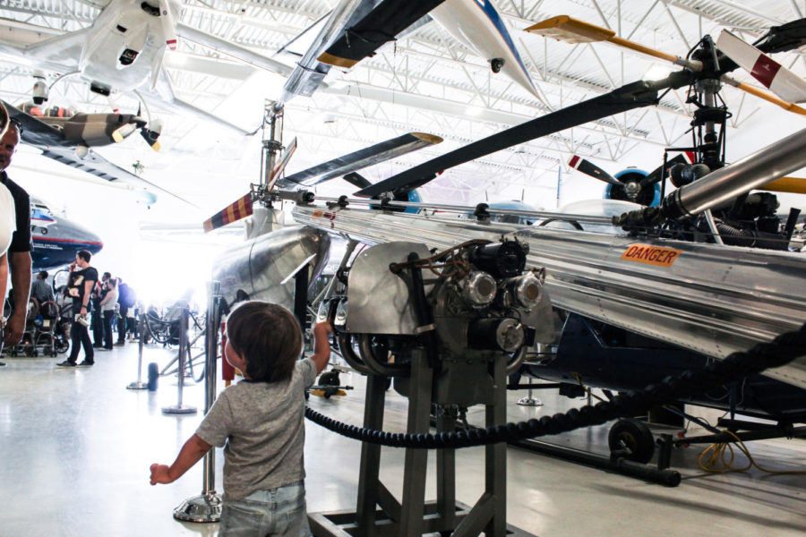 A child explores a plane exhibit in the museum. 