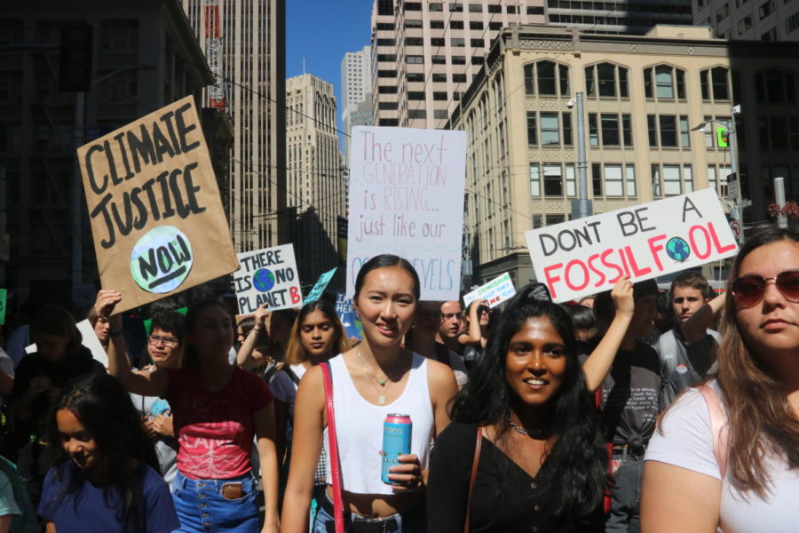 Teenagers+wield+signs+demanding+climate+justice+as+they+march+through+the+streets+of+San+Francisco+on+Sept.+20%2C+2019.