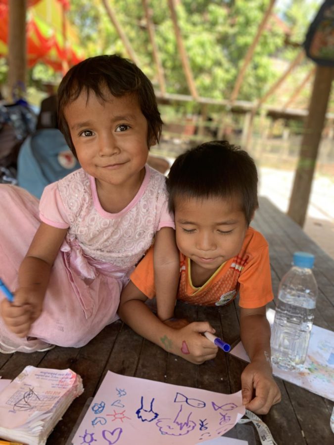 A Cambodian brother and sister smile for the camera.