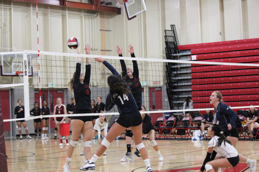 Freshman hitter Curly Raddavero spikes the ball in the first set.