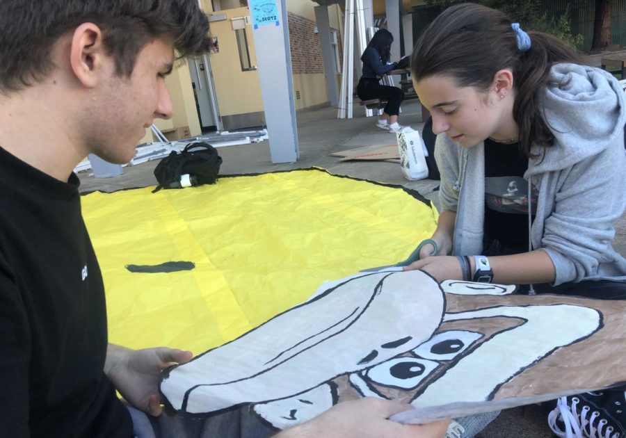 Isabella Peterson, a sophomore, and Bronsen Lasala, a sophomore, cut out a paper Donkey Kong for the sophomore float.