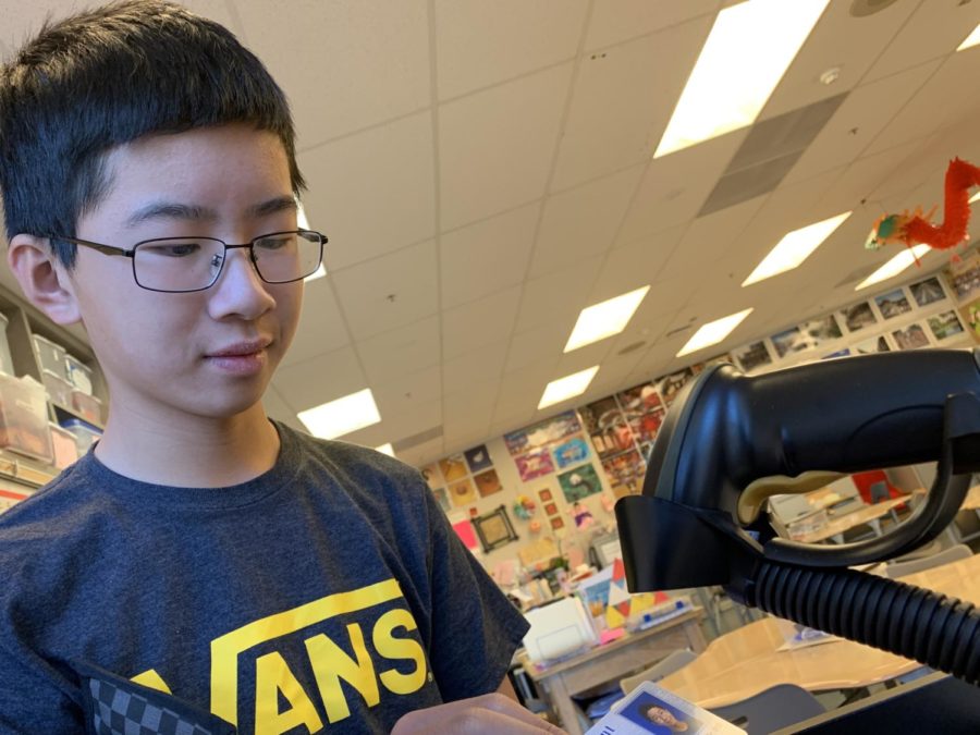 Sophomore Benjamin Lee scans his student ID in Chinese class with the new scanners that were installed for flex time. Carlmont has plans to expand the usage of scanners from just flex time attendance to regular attendance.