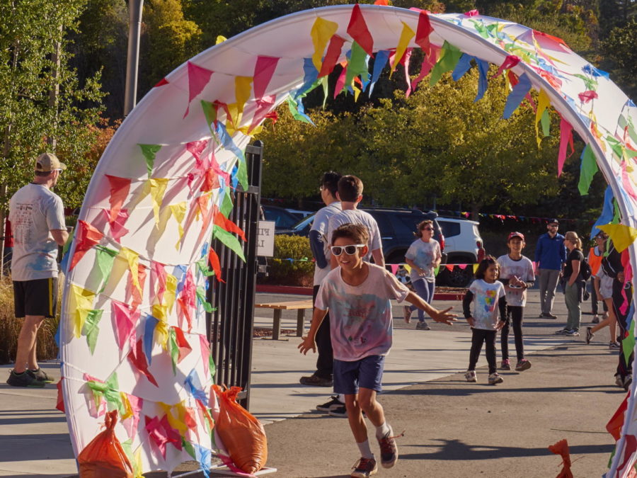 A student crosses the finish line for the Color Run.