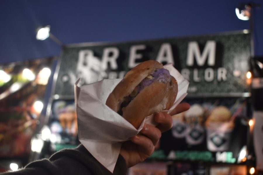 An attendee holds up a DreamBun from the Dream Ice Cream Parlor, one of the many vendors at FoodieLand Night Market.