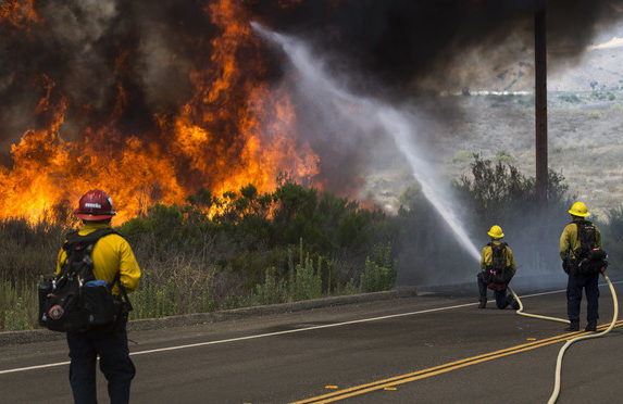 Firefighters with the Camp Pendleton Fire Department combat a fire in the Santa Margarita/De Luz Housing area on Marine Corps Base Camp Pendleton, California, July 6, 2018.(U.S. Marine Corps photo by Cpl. Dylan Chagnon)