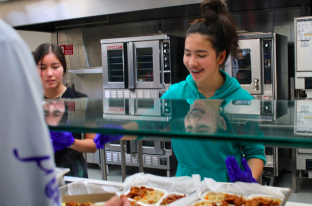 Katinka Lennemann (right) and Cori Nicholson (left) serve students in the lunch line.