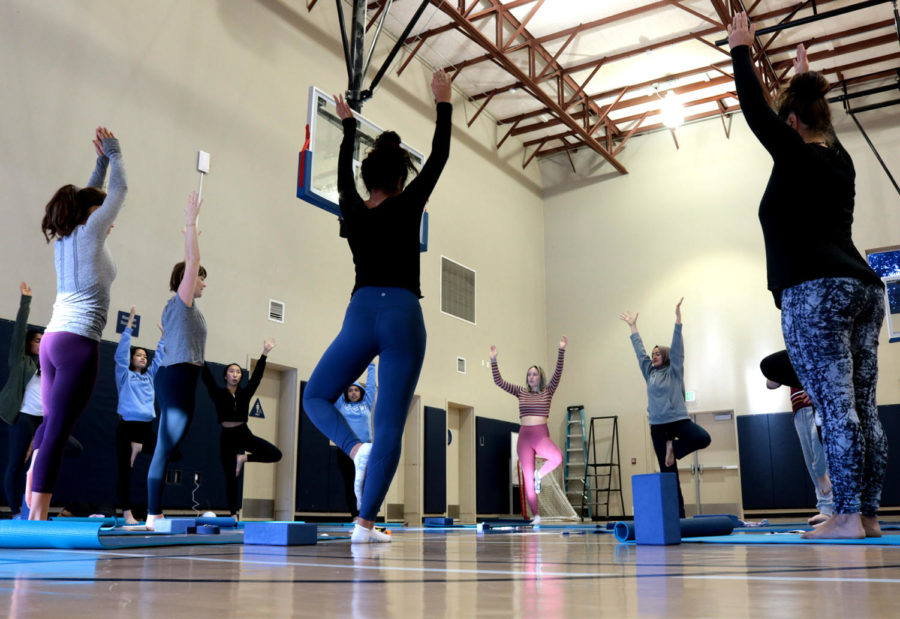 Club members stretch together as relaxing music plays in the background. Yoga is a wonderful antidote to stress, said Ame Secrist, a teacher.