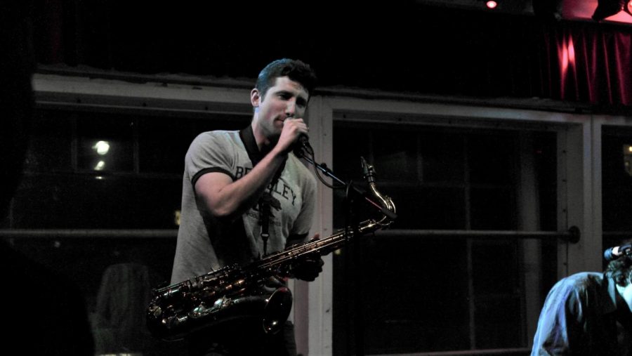 James Garcia of the Apollito band sings and plays the saxophone during a live performance. 