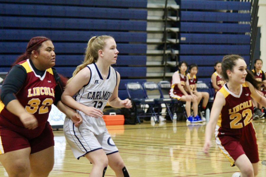 Makya Whiting guards her opponent during an intense  basketball game.