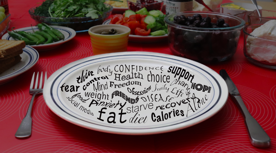 Words associated with disordered eating swim across a plate, while food fills the background.