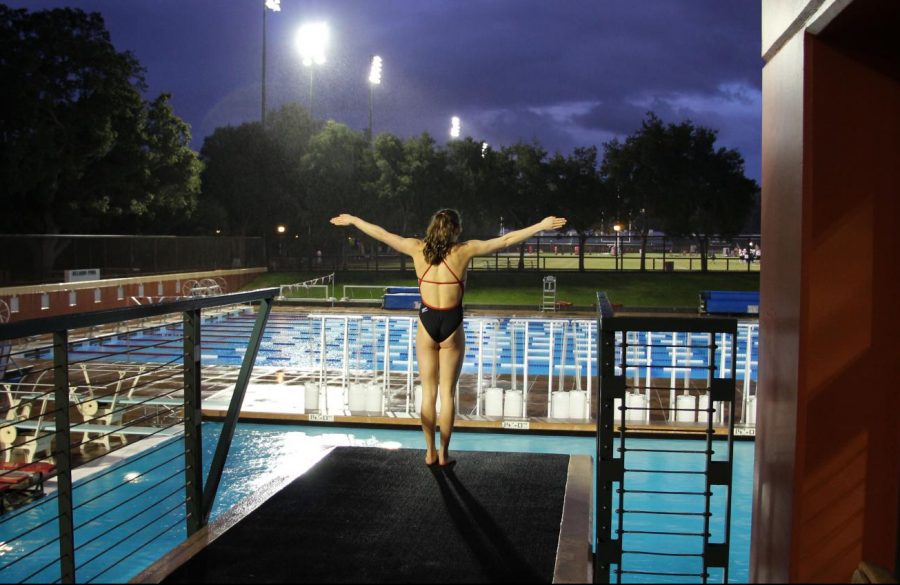 Melina Dimick, a senior, stands at the edge of the platform in preparation for a dive. 