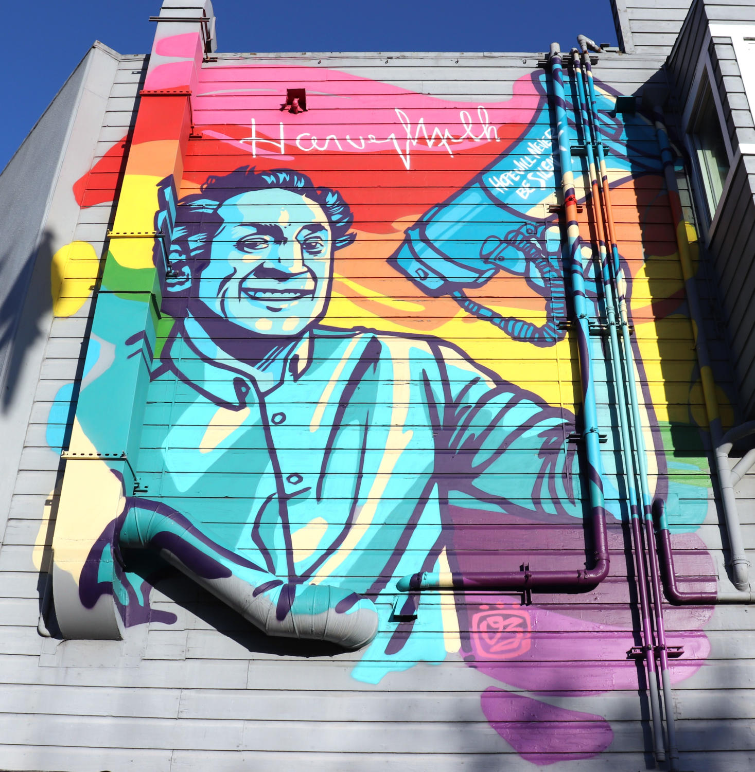A mural of supervisor Harvey Milk smiles down on pedestrians on the corner of 17th and Castro Street in San Francisco.