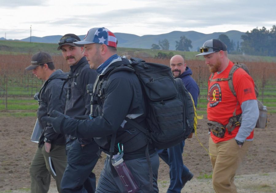 John Preston (center) hikes with a group of local firefighters a week in to his journey.