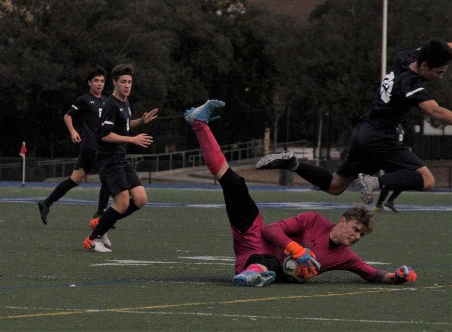 Hillsdale goalkeeper Parker Crouse makes a diving save in the first half.