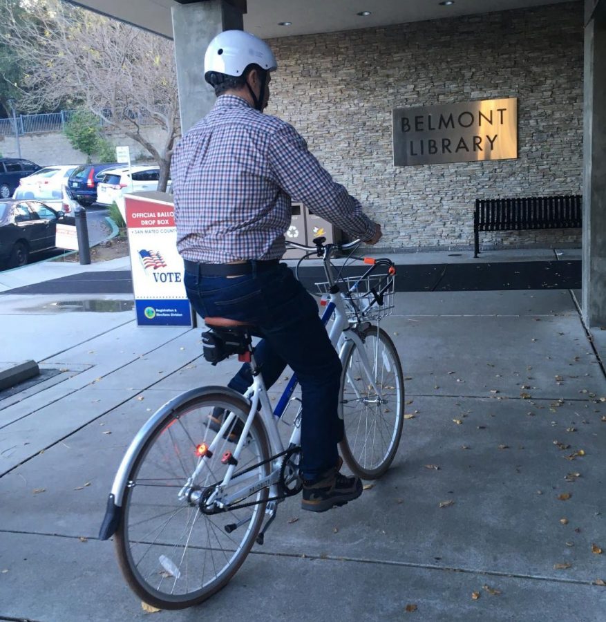 A library member rides down to the Belmont library to return his bike before closing.