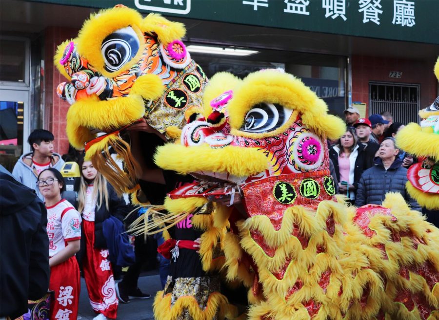 Lion dancers parade through the streets before the ceremony begins.
