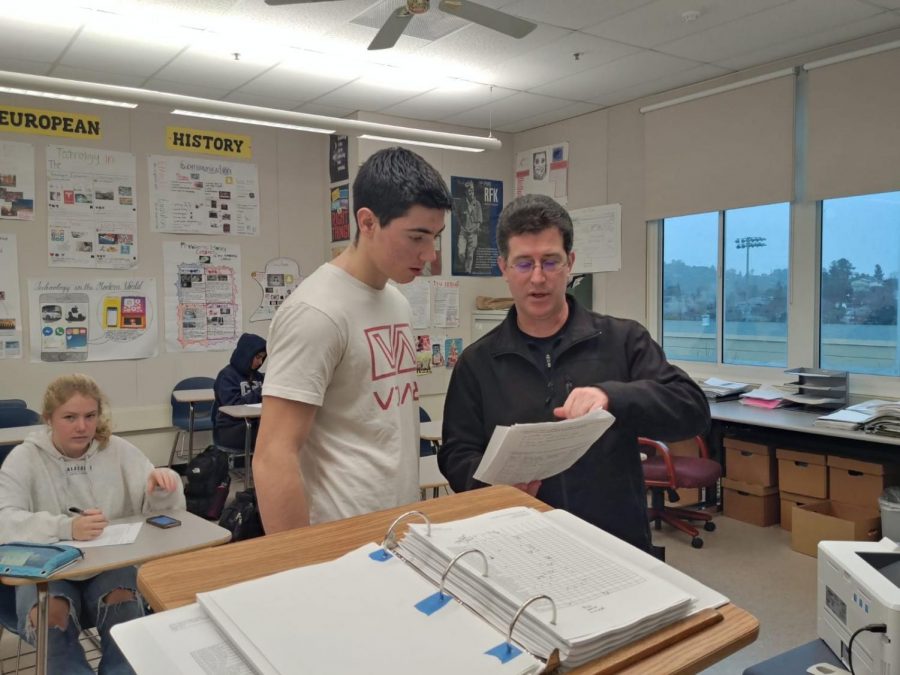 History teacher David Braunstein helps a student with a homework assignment during the Flex period.