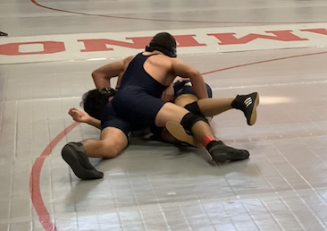Sam Cano gains footing and is able to get on top of his opponent from Leland High School. 