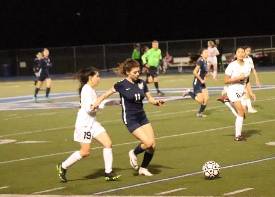 Lara Craciun, a sophomore, pushes the ball up the field in hopes to score.