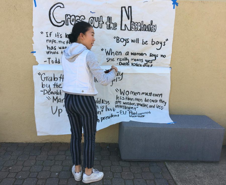 Carolyn Wang, a junior, crosses out sexist quotes.