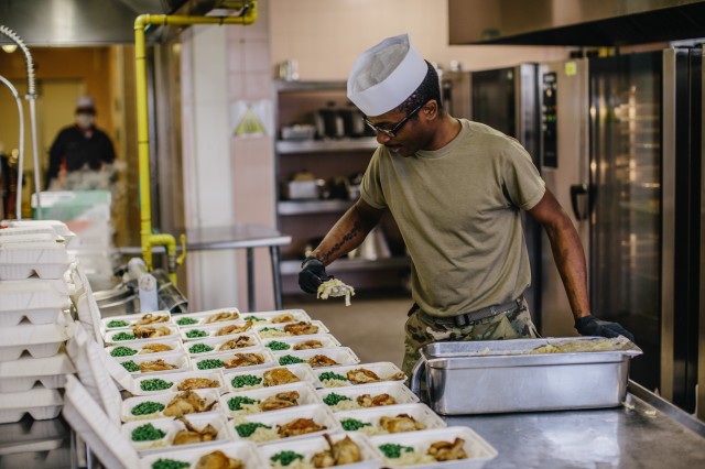 A culinary specialist prepares food as part of the COVID-19 relief effort.
