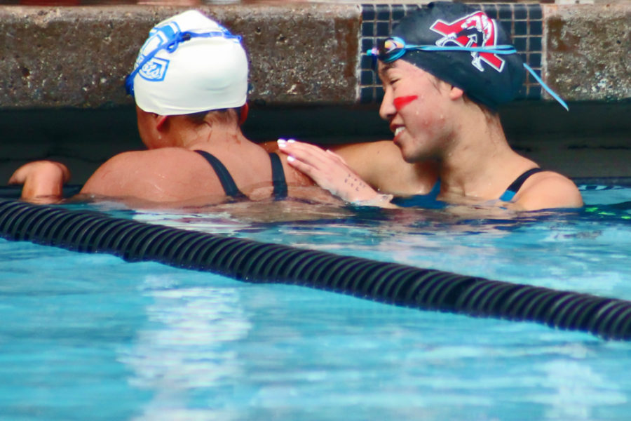 Realizing she won, Li cries tears of joy as Menlo-Atherton swimmer Ava Peyton comforts her. The two girls were head to head in the final stretch with Li winning by a fraction of a second.  