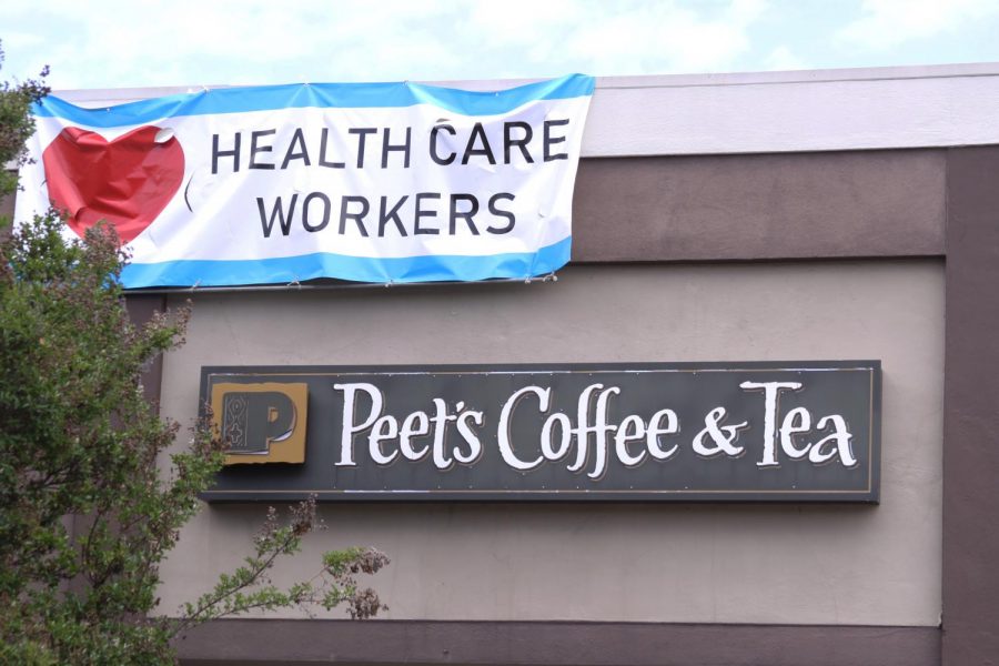 Above Peets Coffee & Tea on Laurel Street flies a simple, yet meaningful, banner. The COVID-19 outbreak has prompted an outpouring of recognition for healthcare workers, many of whom risk their health to care for the sick.
