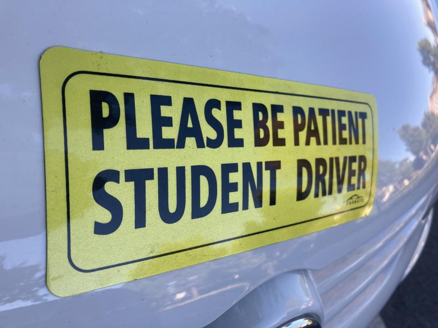 Many teens place bright yellow stickers on their cars when they practice driving, identifying them as student drivers.
