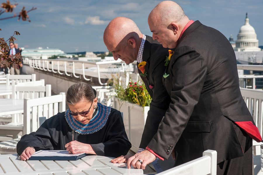 Supreme Court Justice Ruth Bader Ginsberg, fills out David Hagedorn and Michael Widomskis marriage certificate.