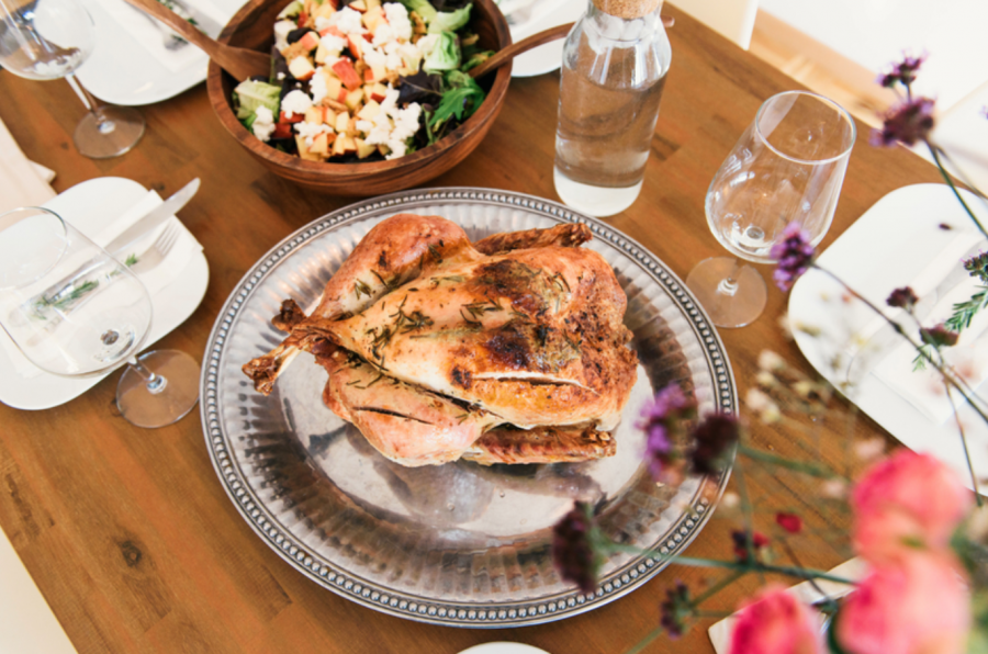 A+turkey+sits+at+the+center+of+a+table+in+preparation+for+a+Thanksgiving+feast.