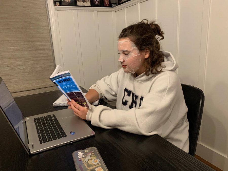 A student attempts to relax with a face mask while studying for finals.
