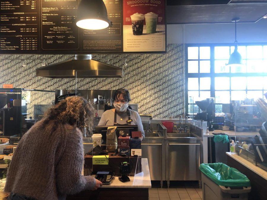 Guillermina Castellanos purchases a drink at Peet’s Coffee in Belmont using her credit card. I prefer paying with a contactless credit card, especially during the pandemic because its safer; I dont have to be exposed to the barista, Castellanos said. 
