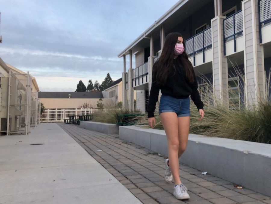 Emily Hall, a sophomore, walks around the school in shorts.