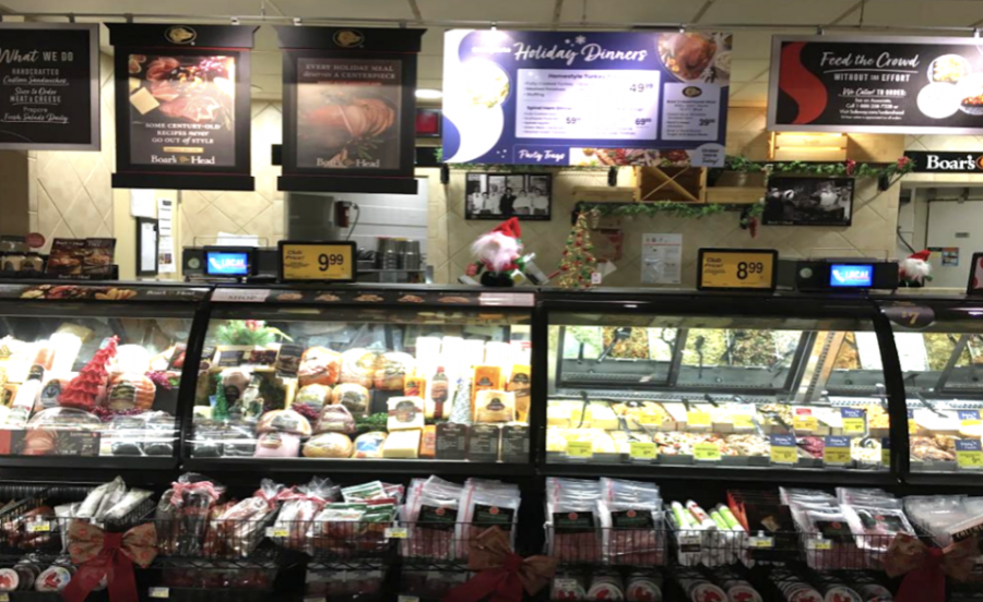 A Safeway in Belmont, CA displays various meat and dairy products along with their according prices.