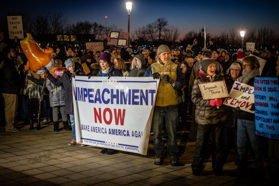 Protestors gather during a rally, calling for the impeachment of President Donald Trump.