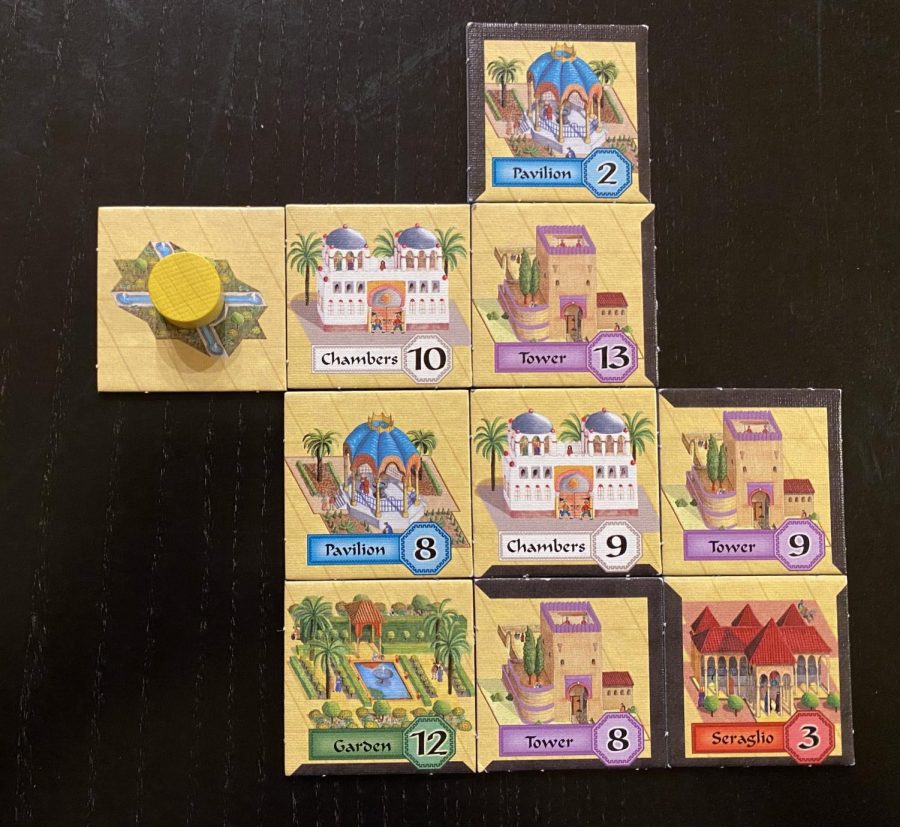 Alhambra is an easy-to-learn game for two to six players that involves collecting money cards and using them to build tiles in an Alhambra. An example of a partially built Alhambra is shown here.