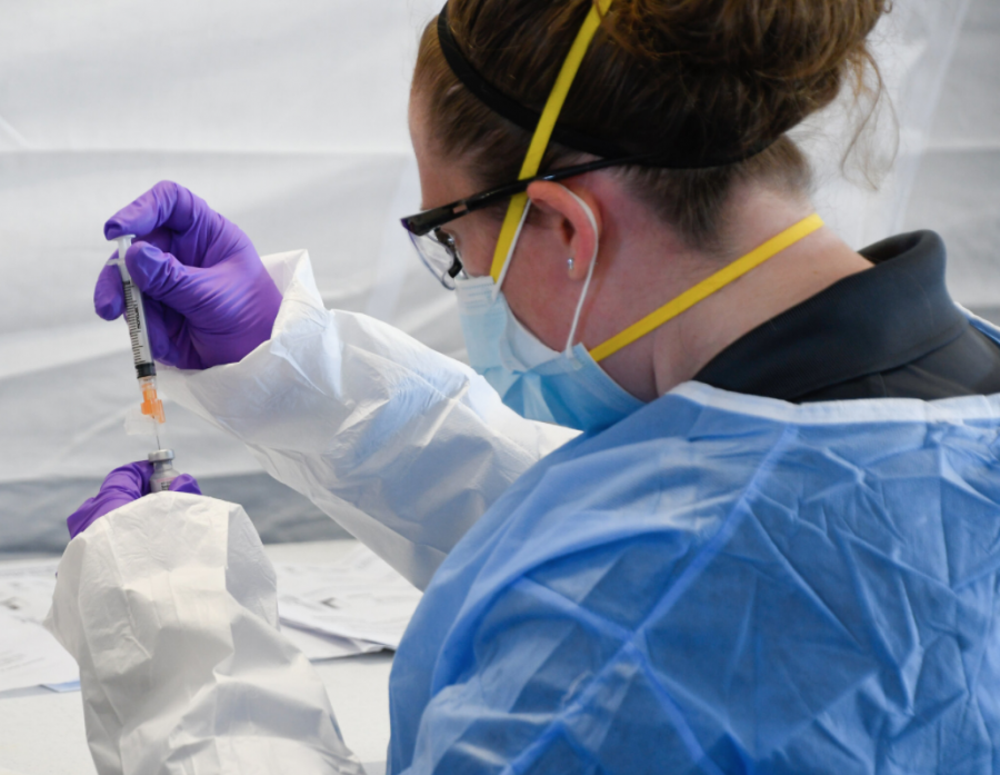 A nurse prepares to administer the COVID-19 vaccine.