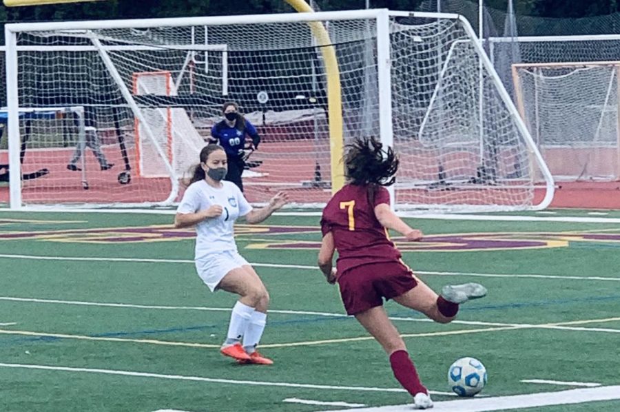 A Menlo-Atherton attacker drives the ball up the field to potentially find an open shot opportunity. 