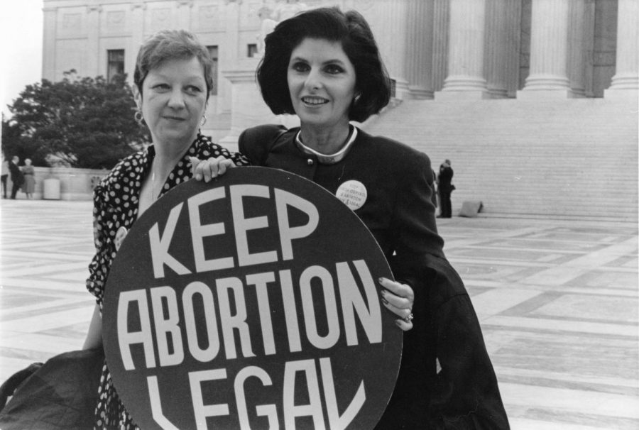 Norma+McCorvey%2C+widely+known+as+Jane+Roe%2C+and+her+lawyer+stand+outside+the+Supreme+Court+in+1989.+At+this+time%2C+the+Supreme+Court+was+trying+Webster+v.+Reproductive+Health+Services%2C+a+case+that+could+have+overturned+Roe+v.+Wade.