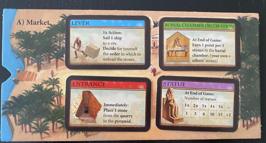 The last site players can sail to is the market.

When a players stone is unloaded here, the player can take any remaining card of their choice.

Blue cards give players an alternate action they can use on their turn. Players can discard a blue card on their turn to do the action on the text. This replaces their regular turn.

Green cards are ornaments and give players points at the end of the game based on how many total stones are at a certain site.

Red cards immediately allow a player to place one stone onto a specific site as if it was just unloaded there.

Purple cards are statues. Players get points at the end of the game based on the number of Statue cards they have.