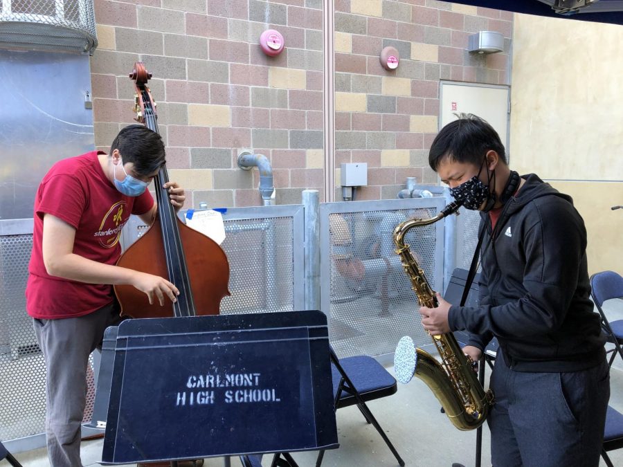 Ethan Htun (right) and Lorenzo Wolczko (left) play jazz music together during lunch with instrumental masks and covers.