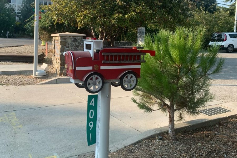 A post with a firetruck at the top outside of Station 19 of the Woodside Fire Department.