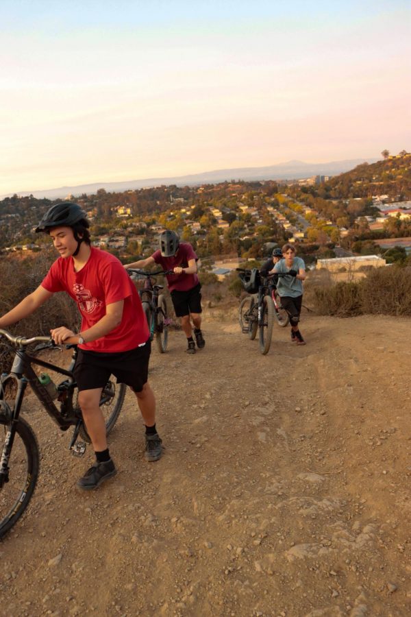 Members of the Carlmont mountain bike club hike up for another run. 